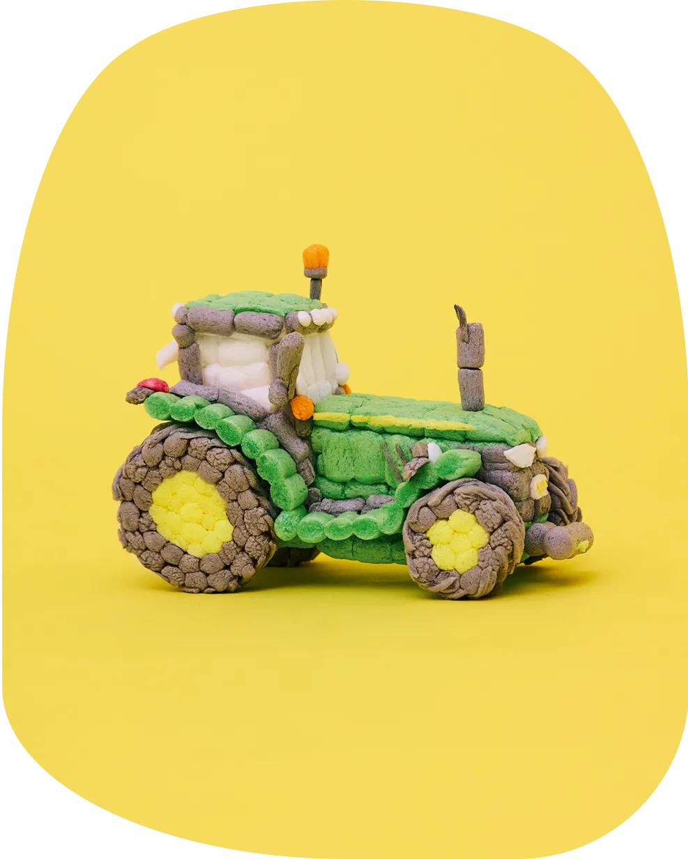 Traktor aus Playmais Classic-Teilen, hauptsächlich in den Farben Grün, Gelb, Braun.